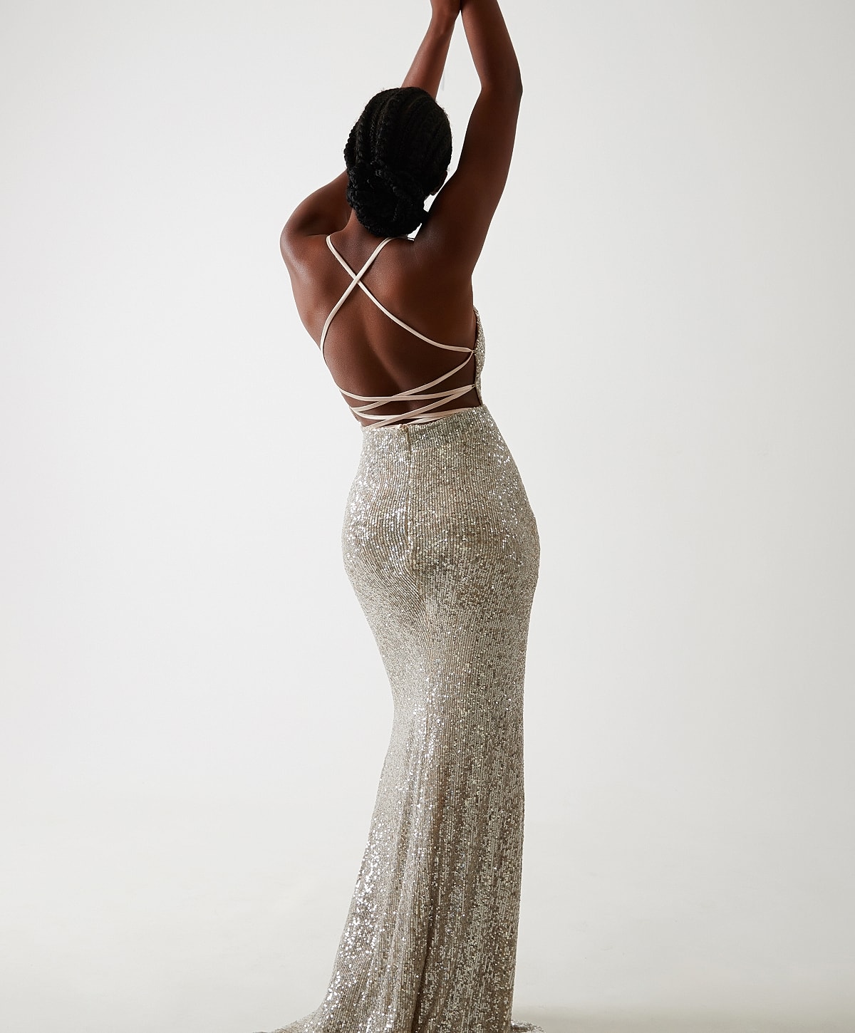 Abuja Liposculpture model in sparkly silver evening gown, back view.