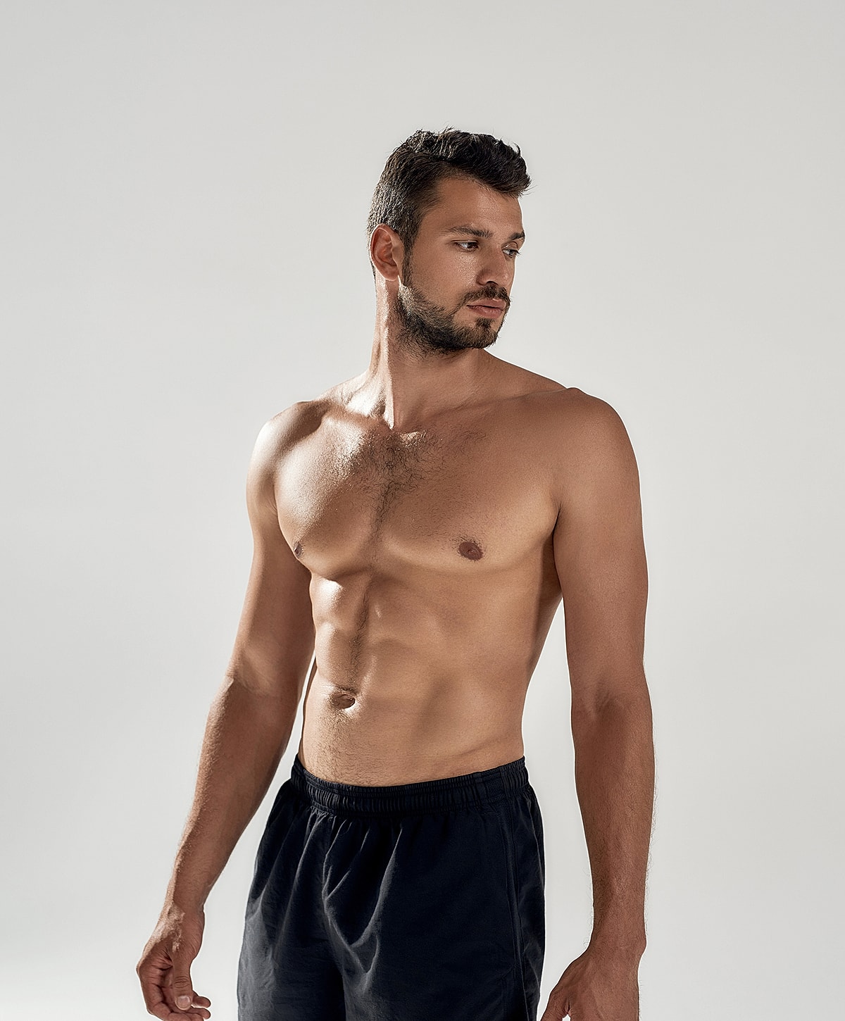 Man with an athletic build, standing confidently.