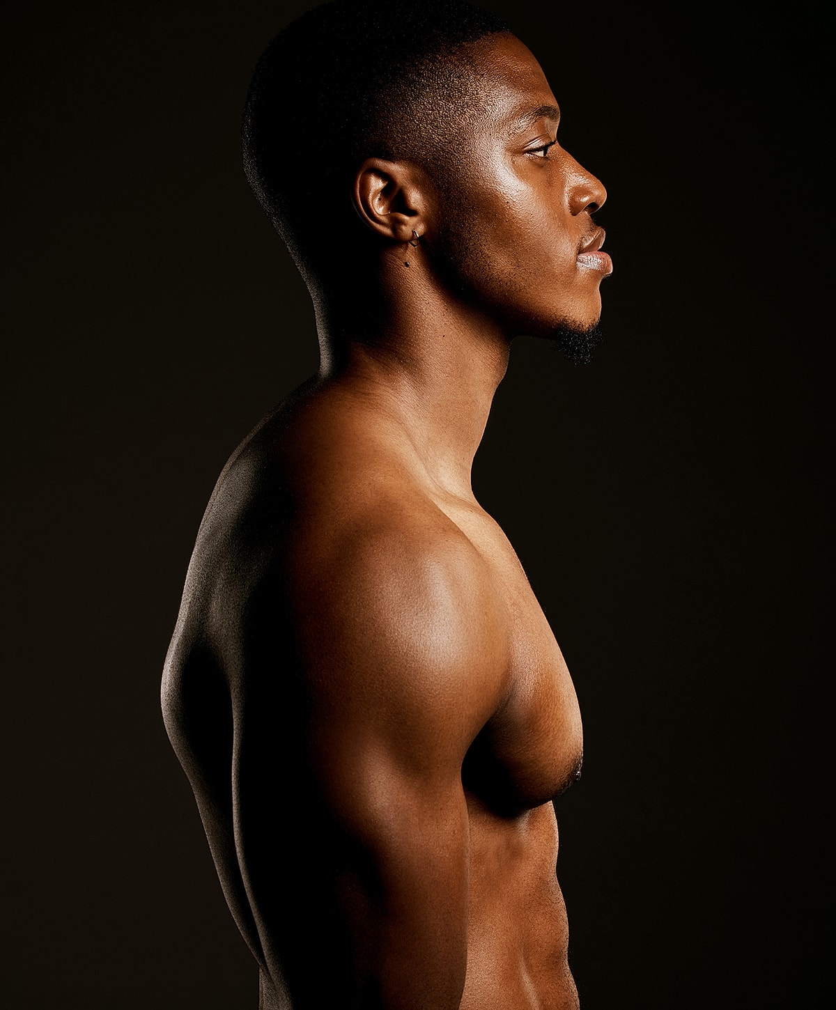 Profile shot of a muscular man.