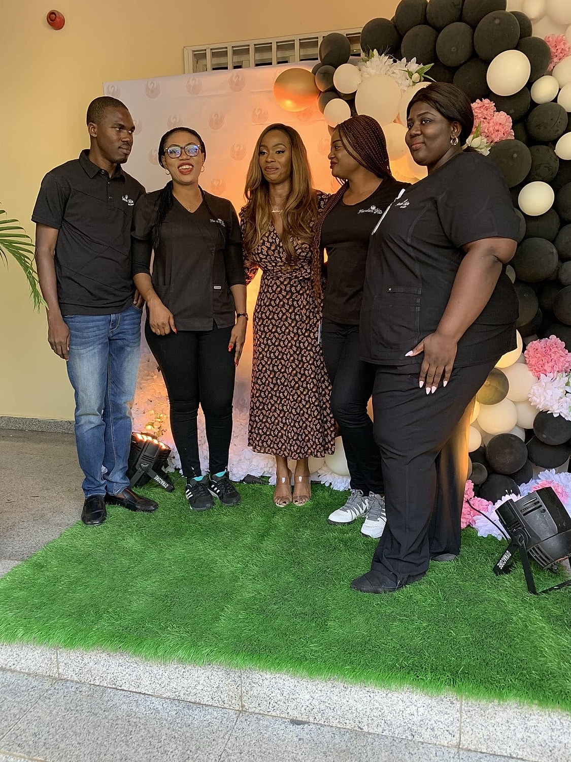 Group photo at a festive event backdrop.