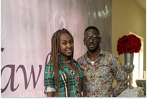 Couple posing at an event backdrop.