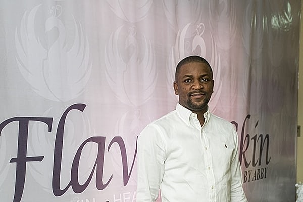 Man in white shirt at promotional event.