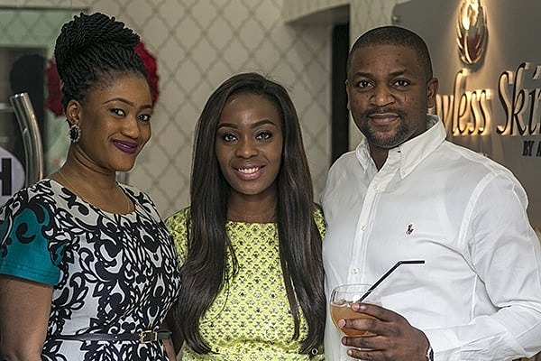 Three people posing together at an event.