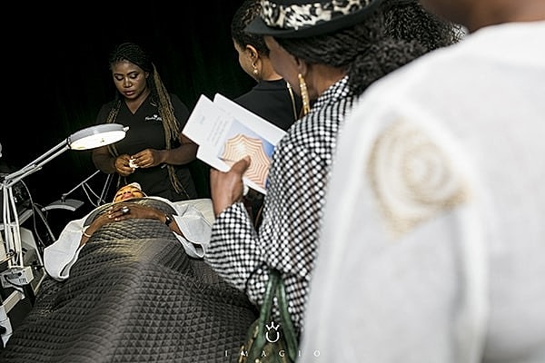 Beauty treatment session with attentive audience observation.