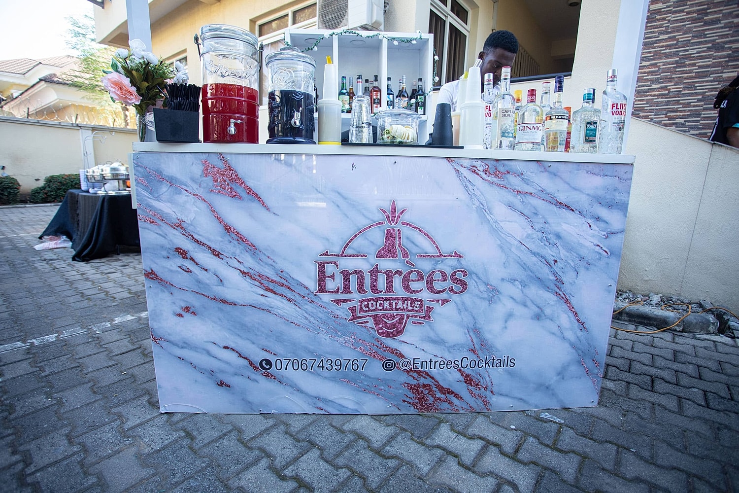 Cocktail bar with drinks and decorations displayed.