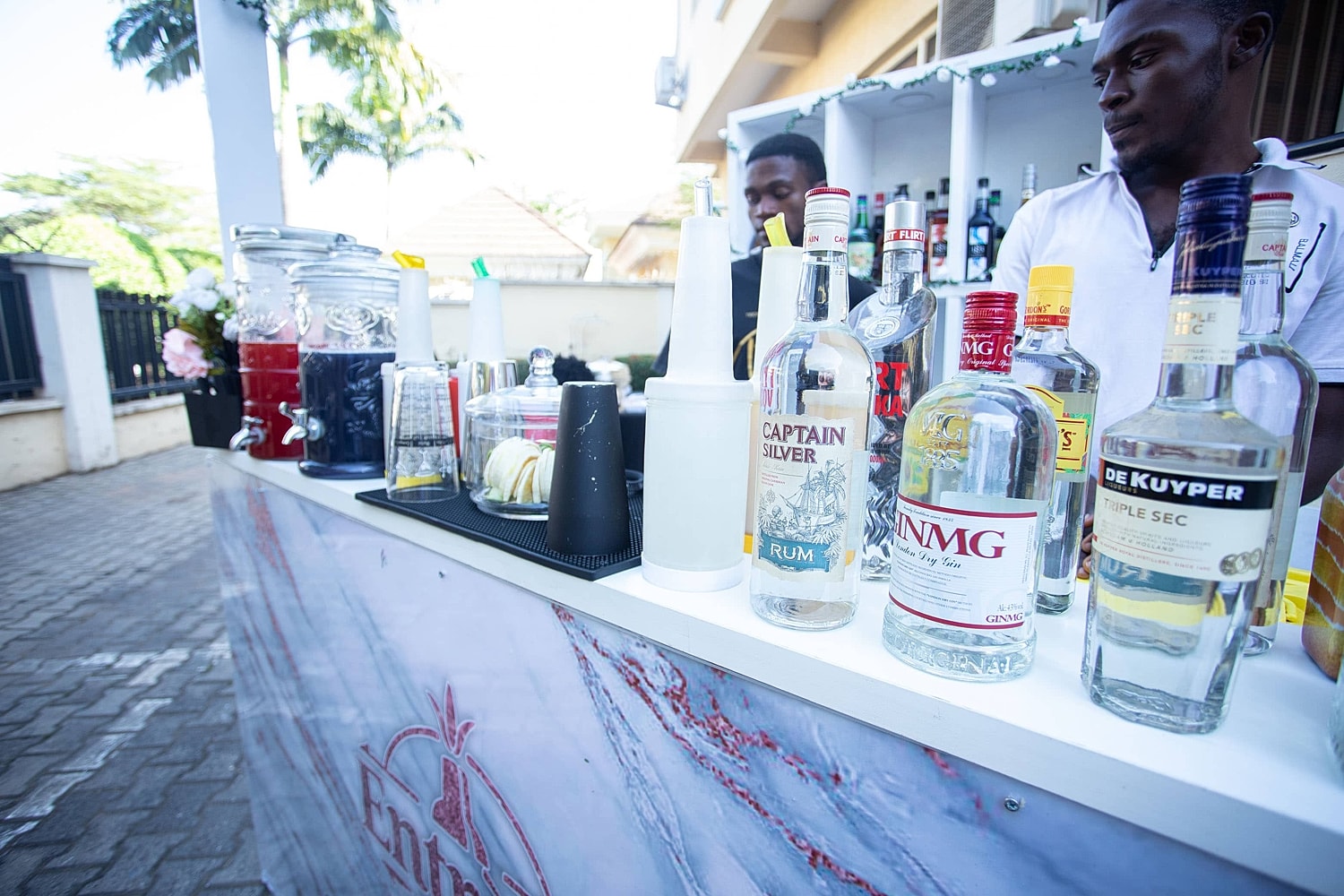 Bar setup with various bottles of alcoholic beverages.