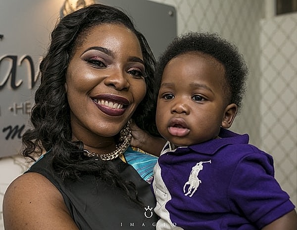 Mother and child smiling together indoors.
