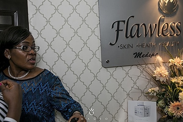 Woman at Flawless Medspa reception area.