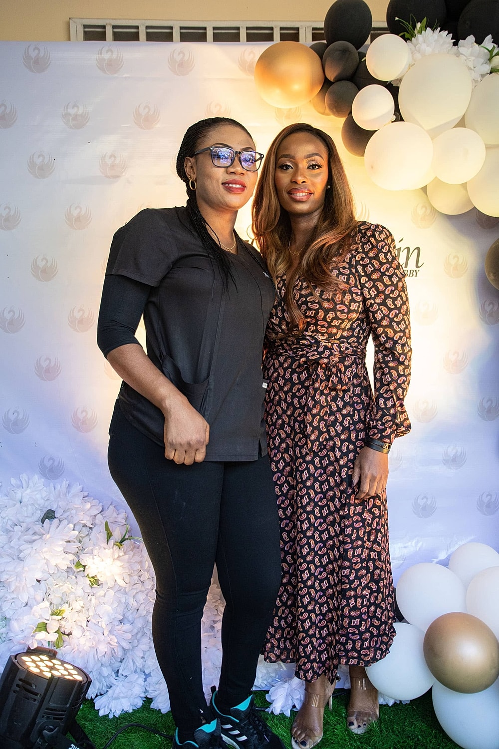 Two women posing at a festive event.