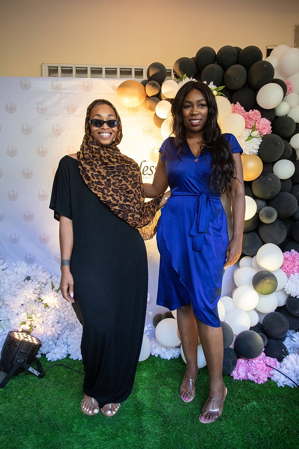 Two women posing at a festive event.