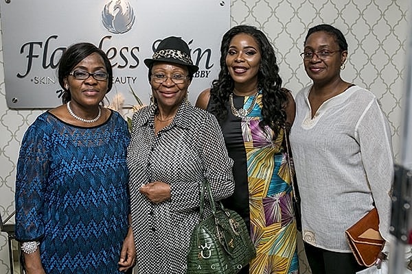 Four women posing at a beauty salon event.