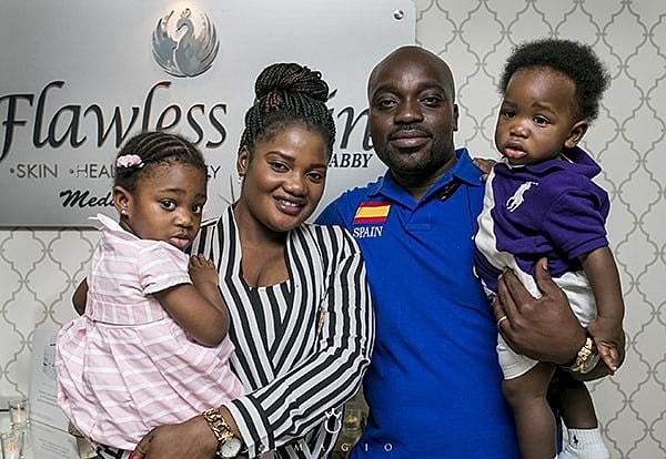 Family posing together at a celebratory event.