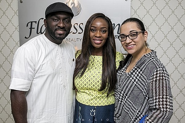 Three smiling individuals at a beauty event