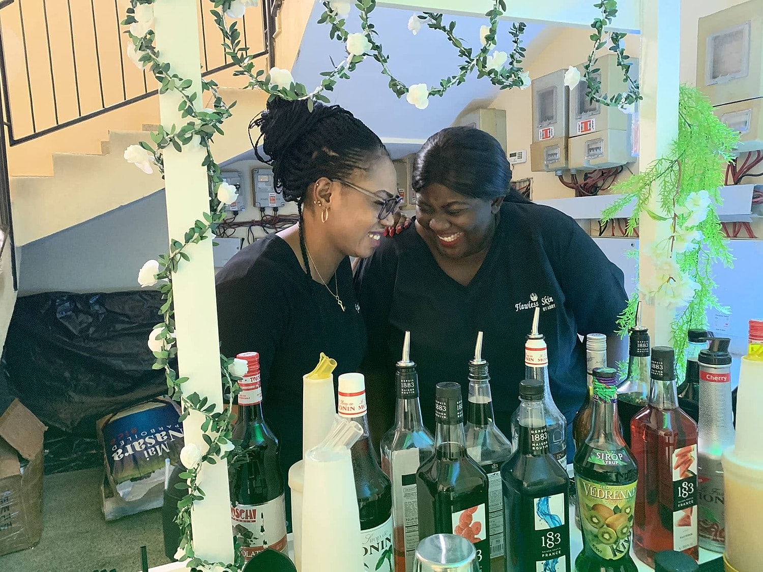 Two women enjoying a moment at a bar.