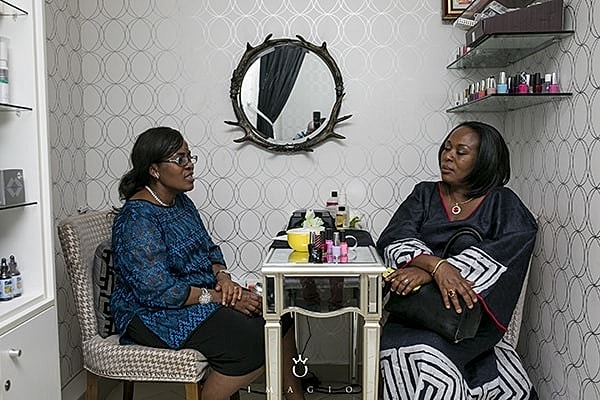 Two women chatting in a cozy salon.