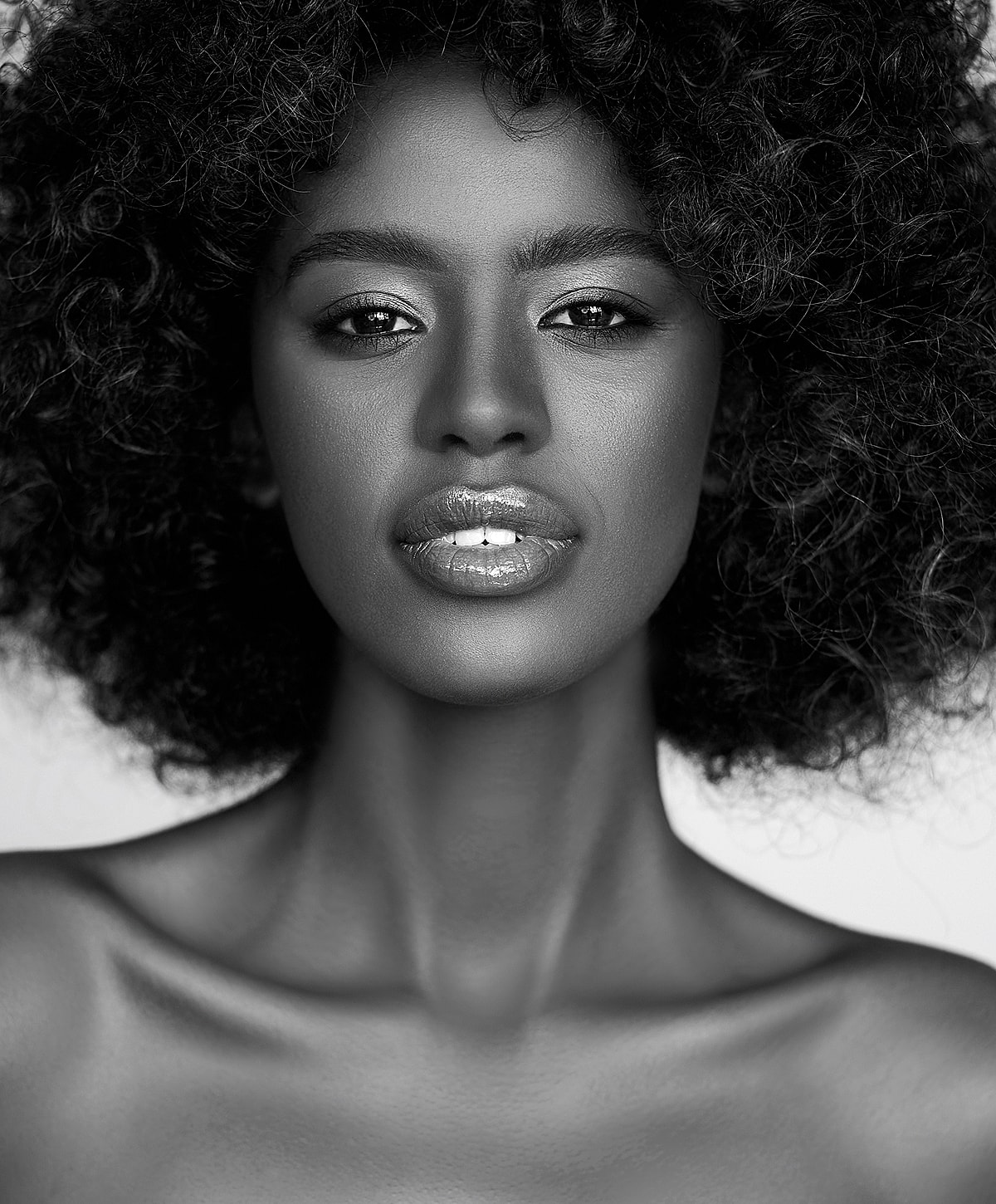 Abuja Kybella with beautiful skin and red nail polish.