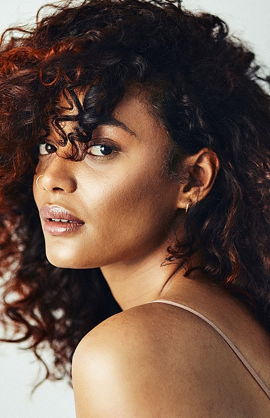 Woman with curly hair, side profile, natural beauty.