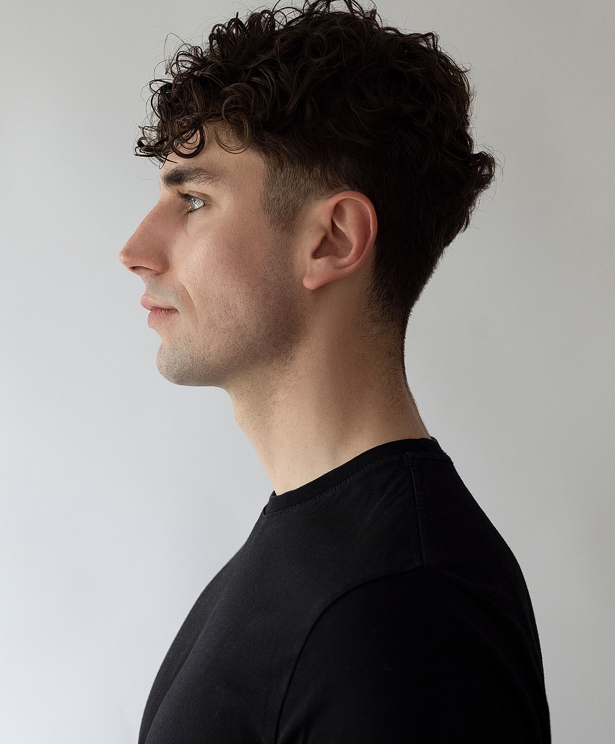 Abuja Kybella for Men model with curly hair.