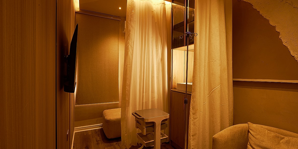 Cozy, private space with soft lighting and furnishings.