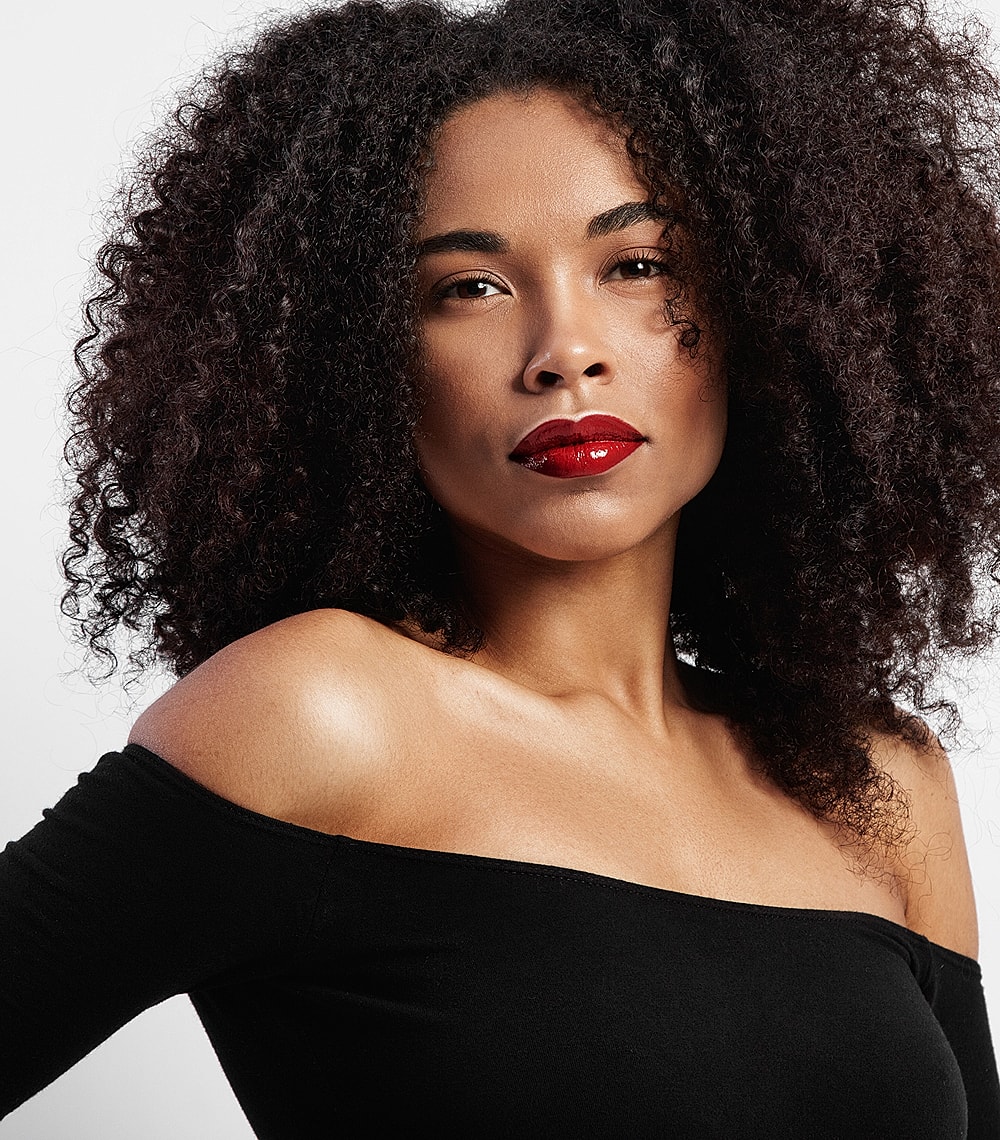 Woman with curly hair and bold red lips