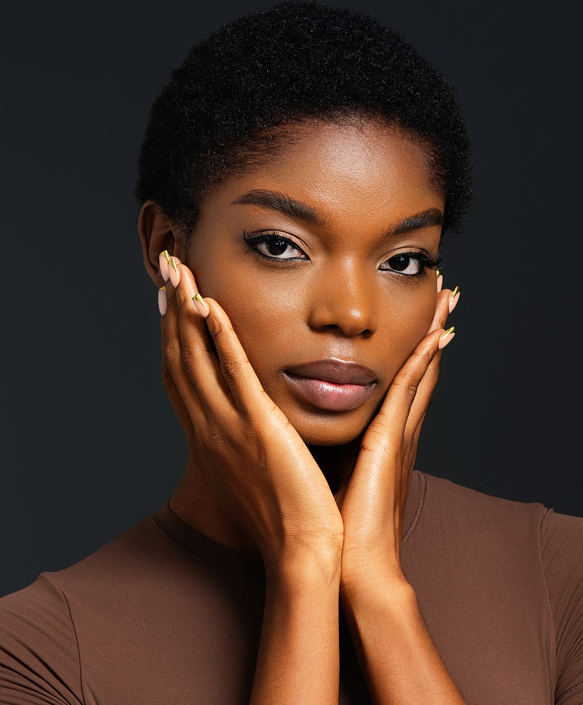 Abuja Microneedling model with short hair and stylish nails.