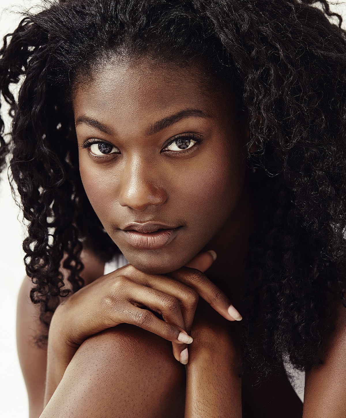 Abuja Dermafrac model with curly hair.