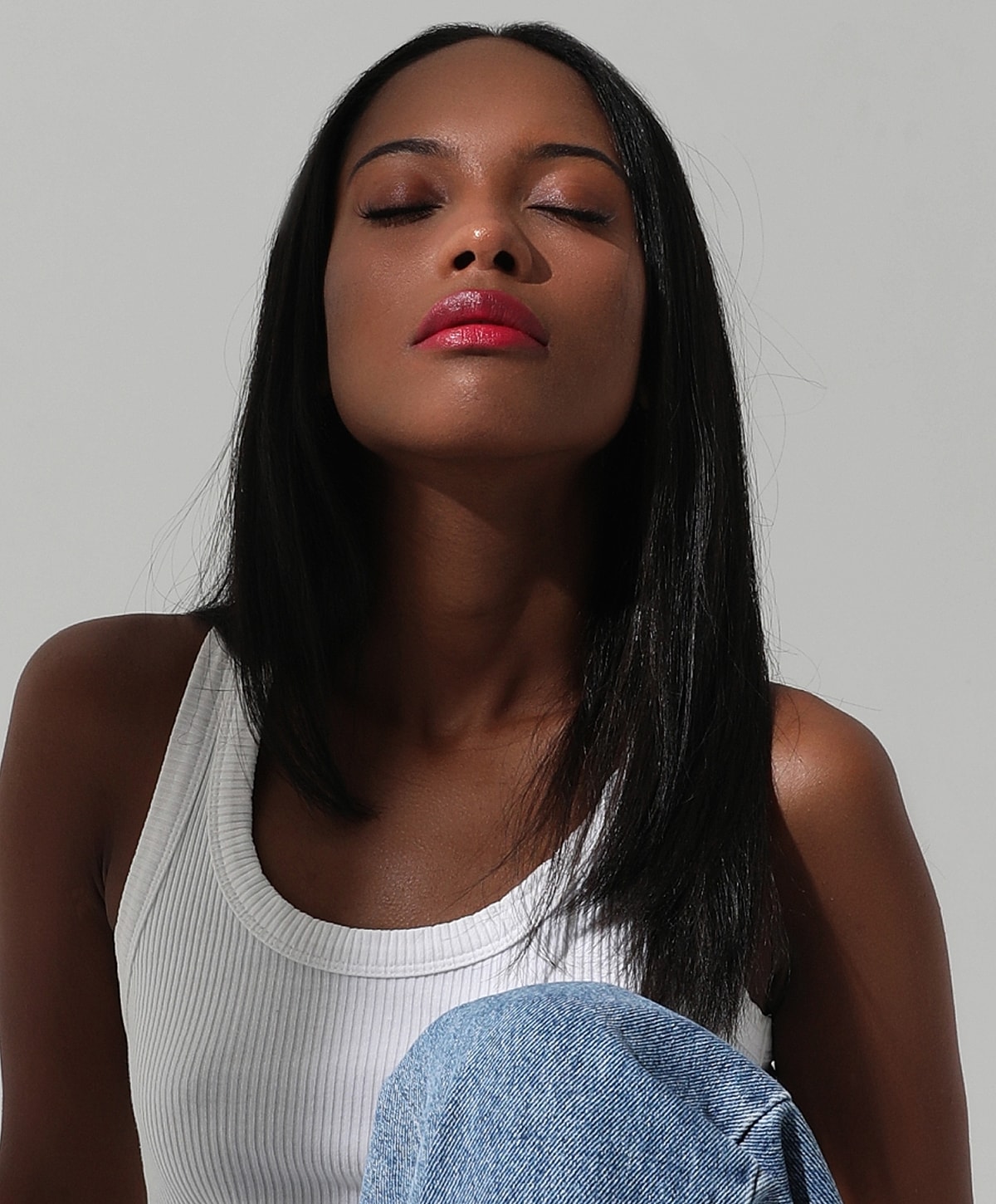 Abuja Morpheus8 Model with closed eyes, wearing a white tank top.