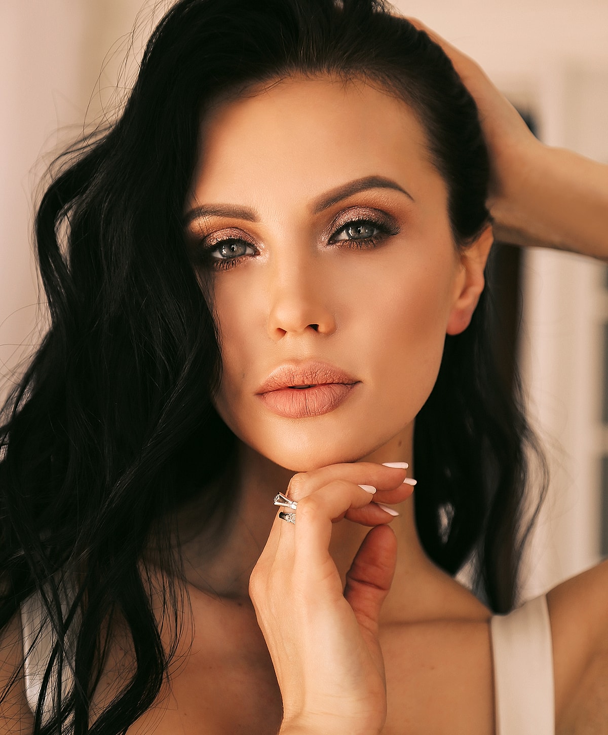 Abuja Hydrafacial model with curly hair and glamorous makeup.