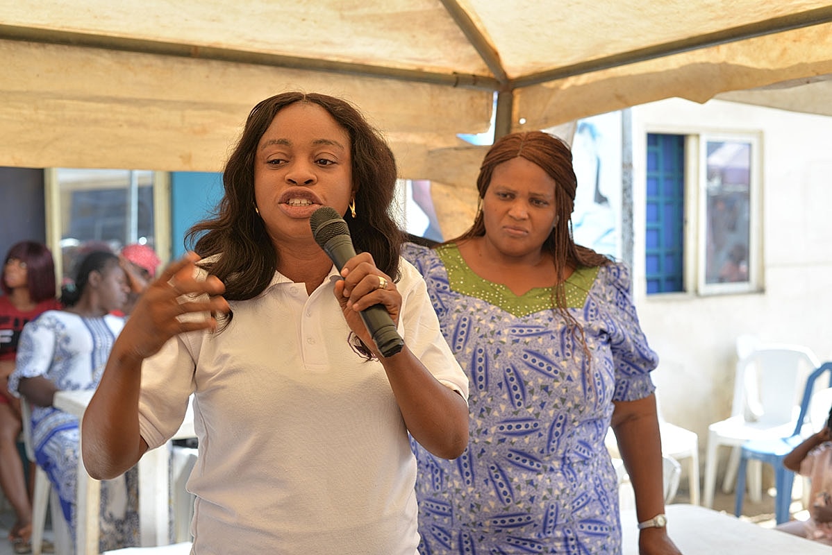 Woman speaking passionately at community event.