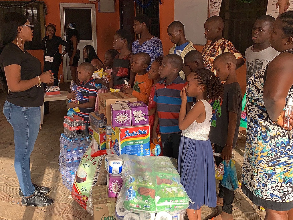 Community gathering distributing supplies to children.