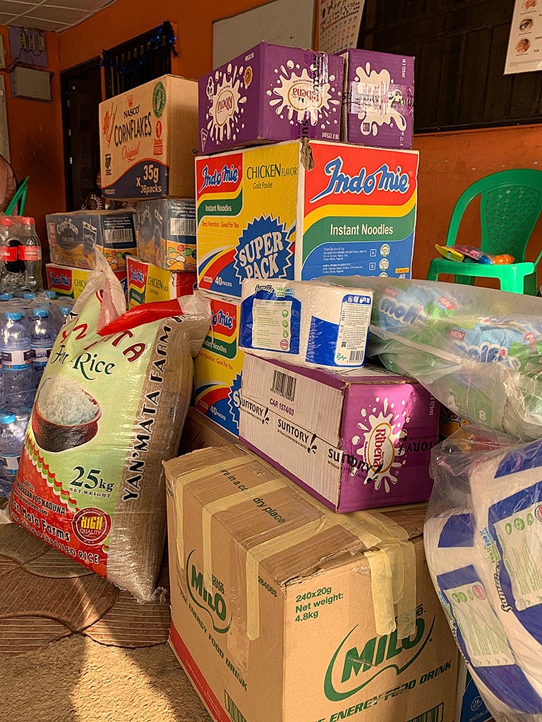 Assorted grocery items stacked in a market.
