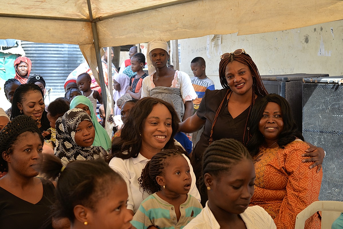 Women and children gathering in a community event.