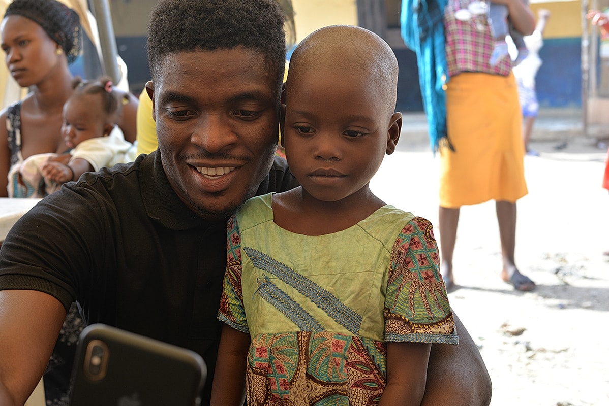 Man and child taking a selfie together.