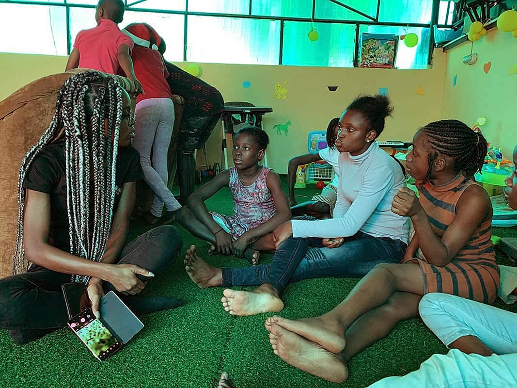 Children engaged in discussion indoors.