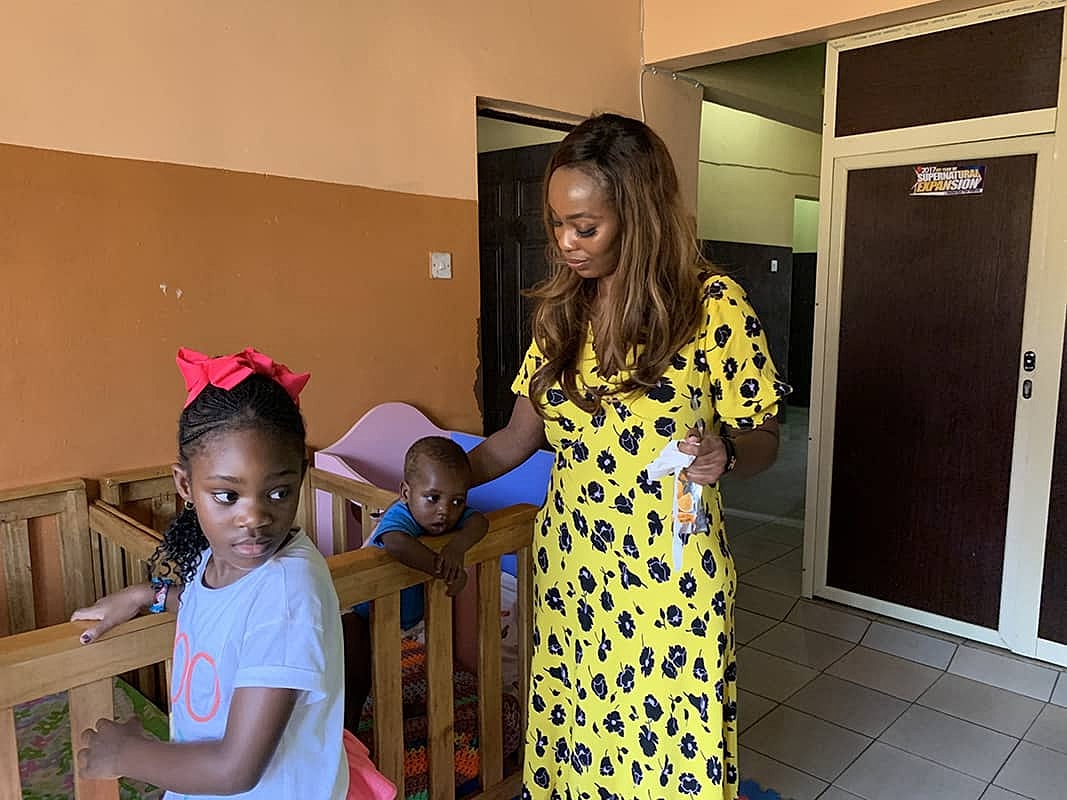 Woman and children in indoor play area.