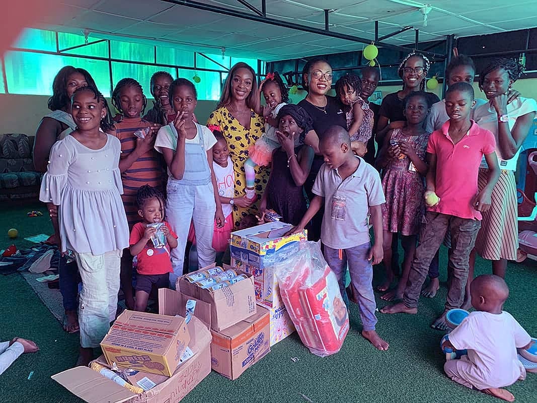 Group of children and adults with donations.