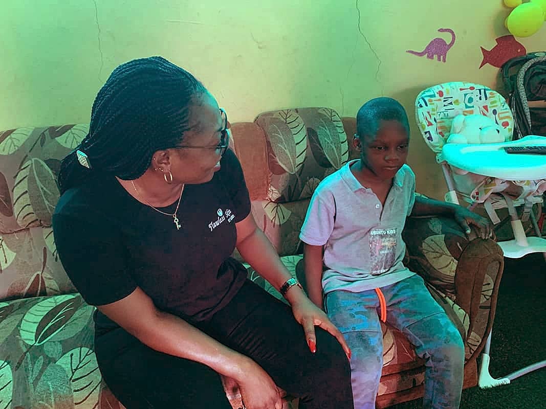 Woman and child sitting on a couch.