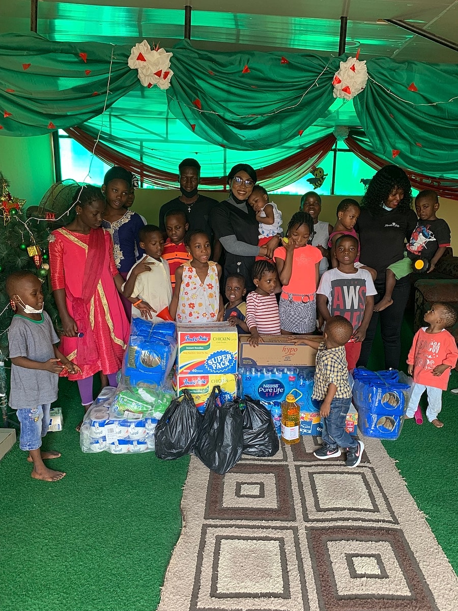 Group of children with donated supplies and gifts.