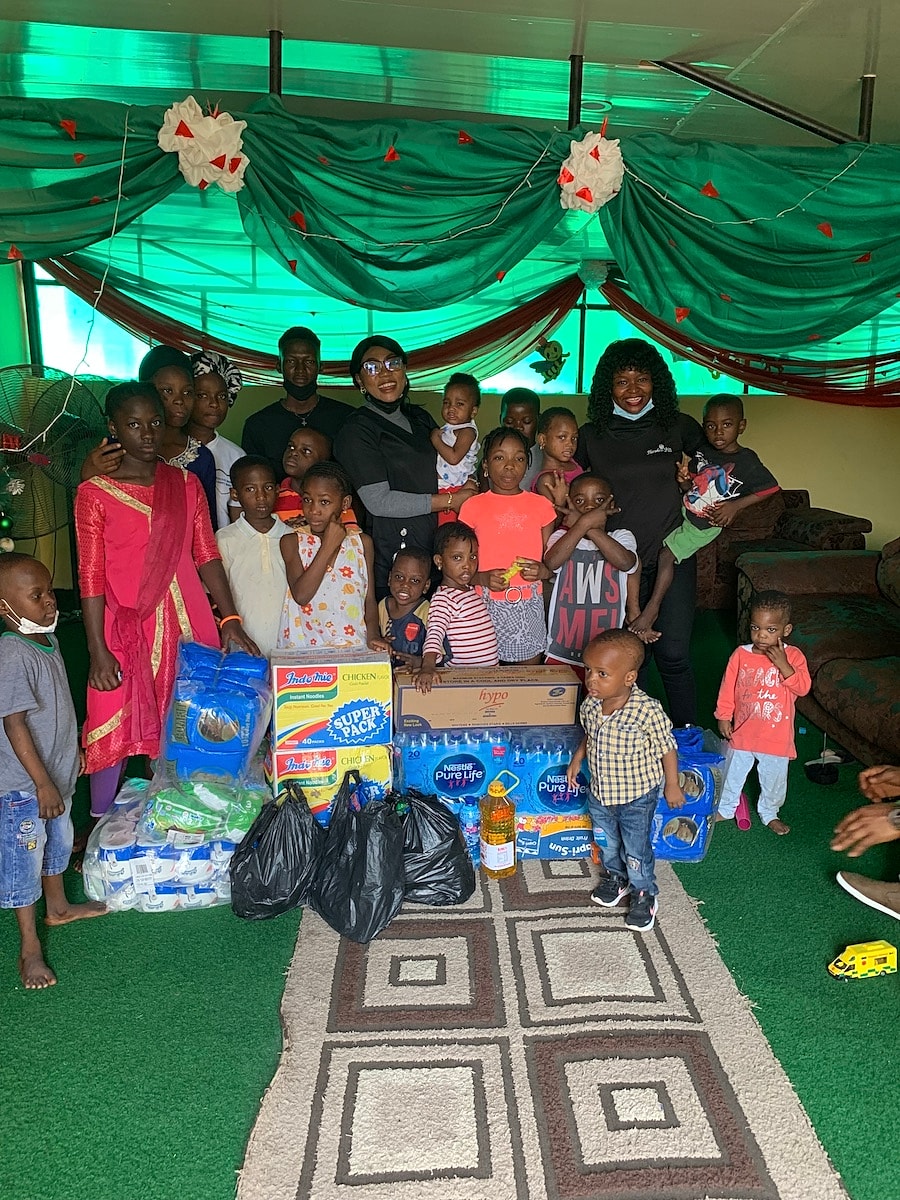 Community gathering with children and donations.