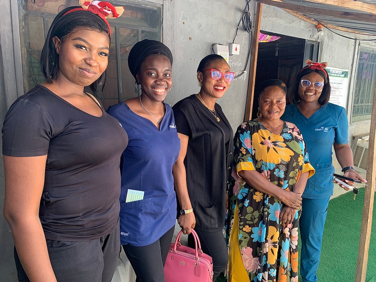 Group of women smiling together outside.