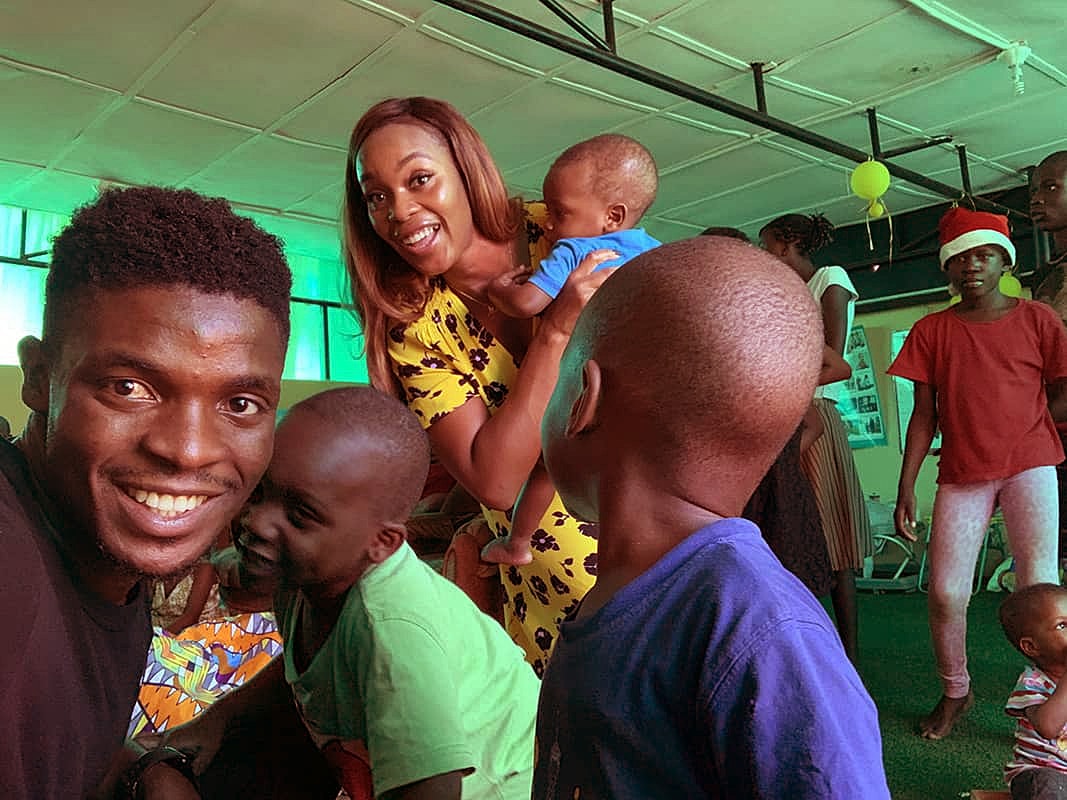 Smiling group of children and adults at event.