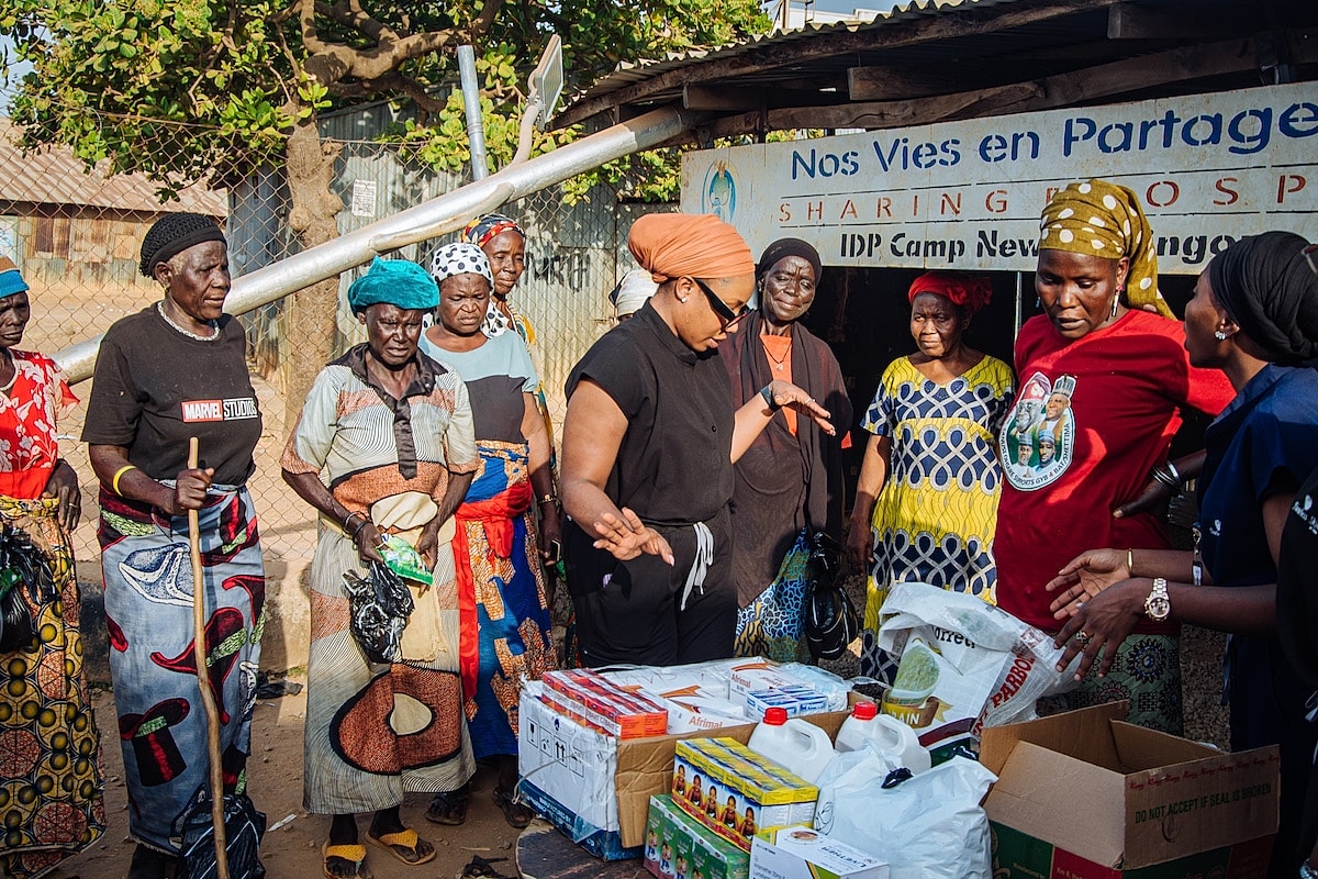 Women gathering for community aid distribution event.