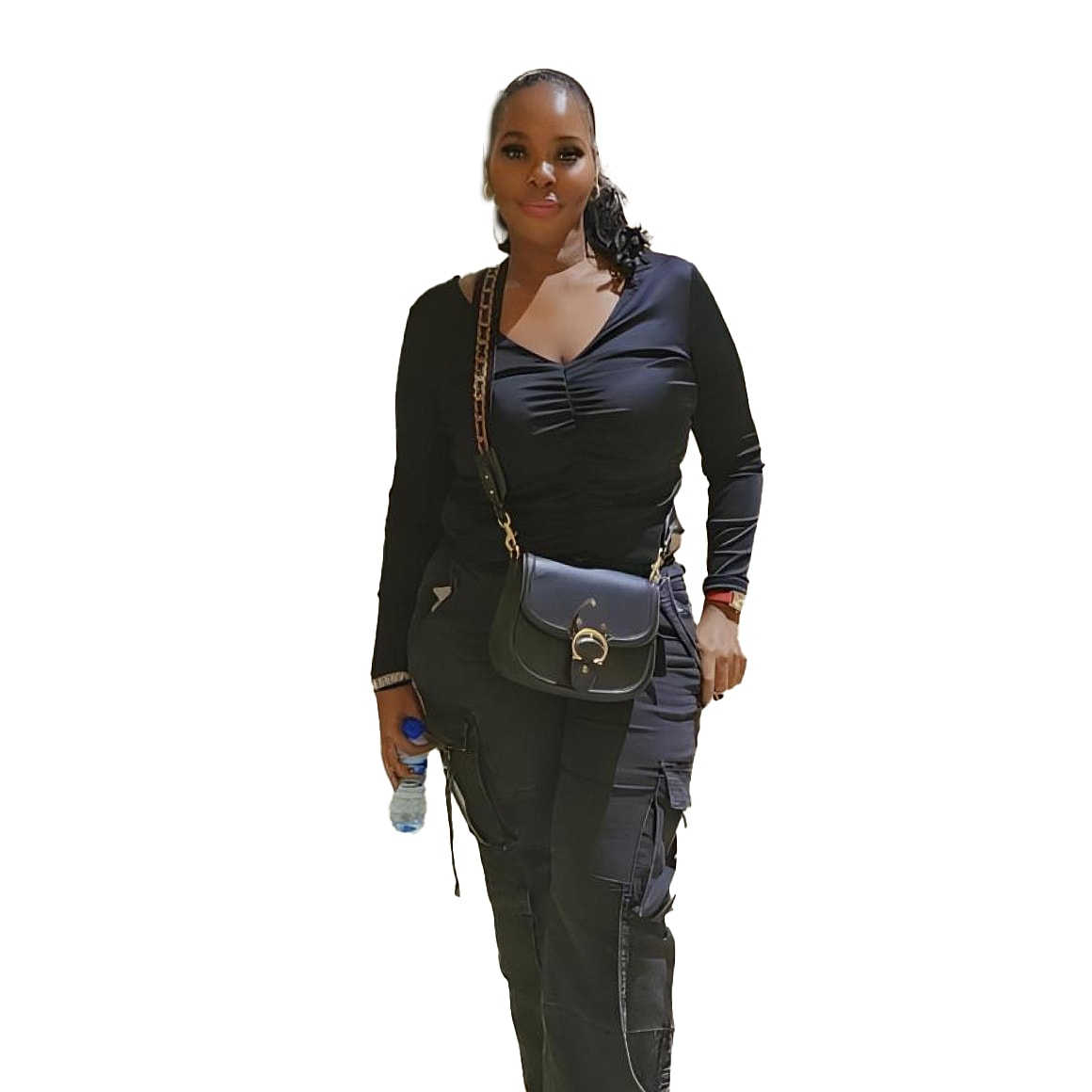 Woman wearing black outfit, holding water bottle.