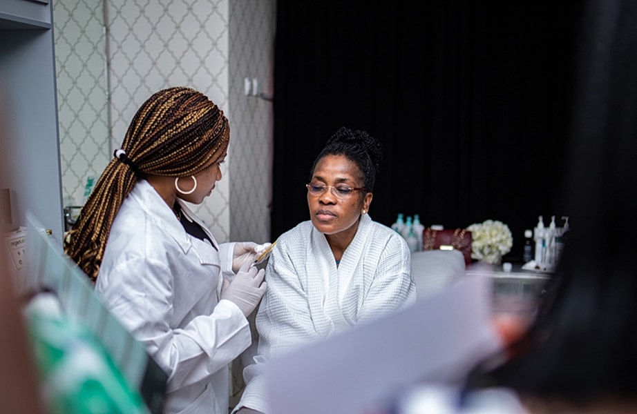 Client receiving skincare treatment in salon setting.