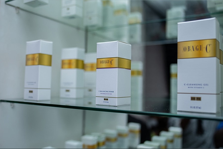 Obagi C skincare products on glass shelf.