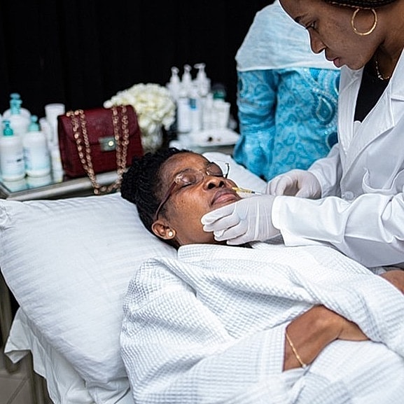 Woman receiving facial treatment at spa.