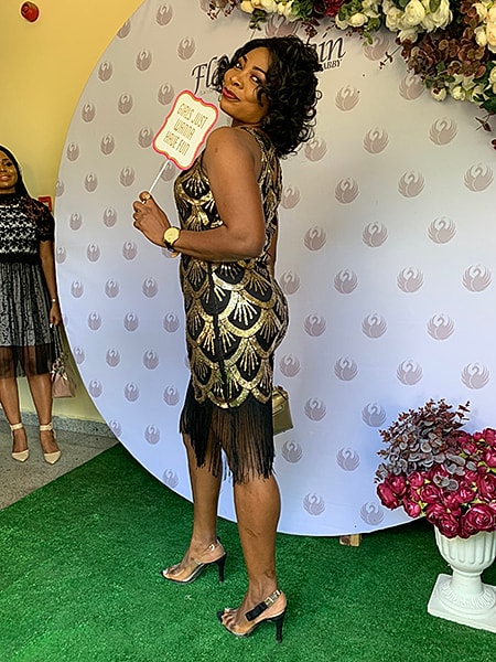 Woman in elegant dress posing at event.