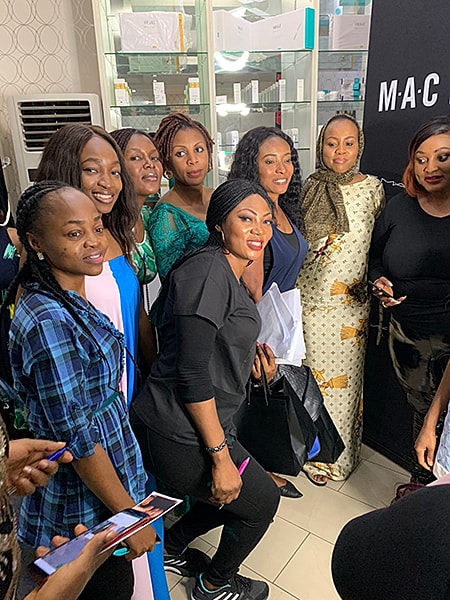 Group of women smiling together indoors.