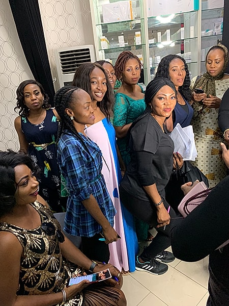 Group of women at MAC event, smiling together.