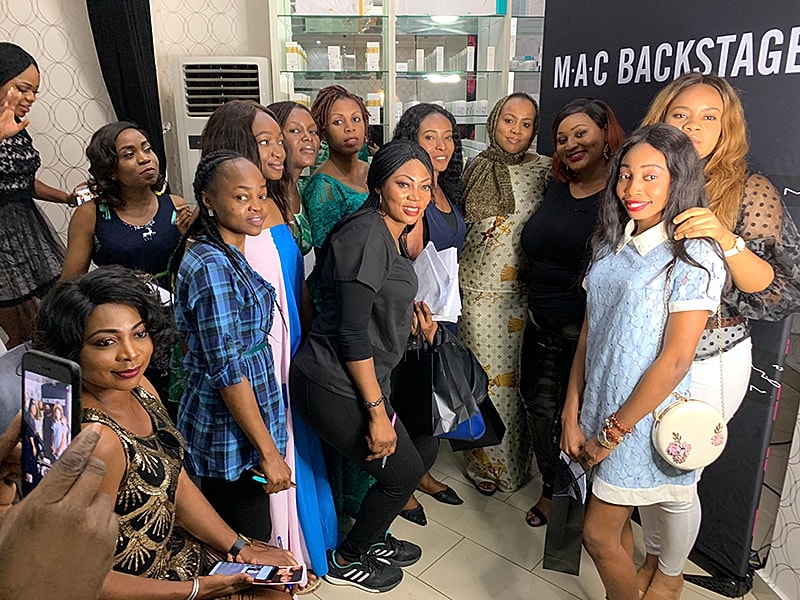 Group of diverse women posing together indoors.